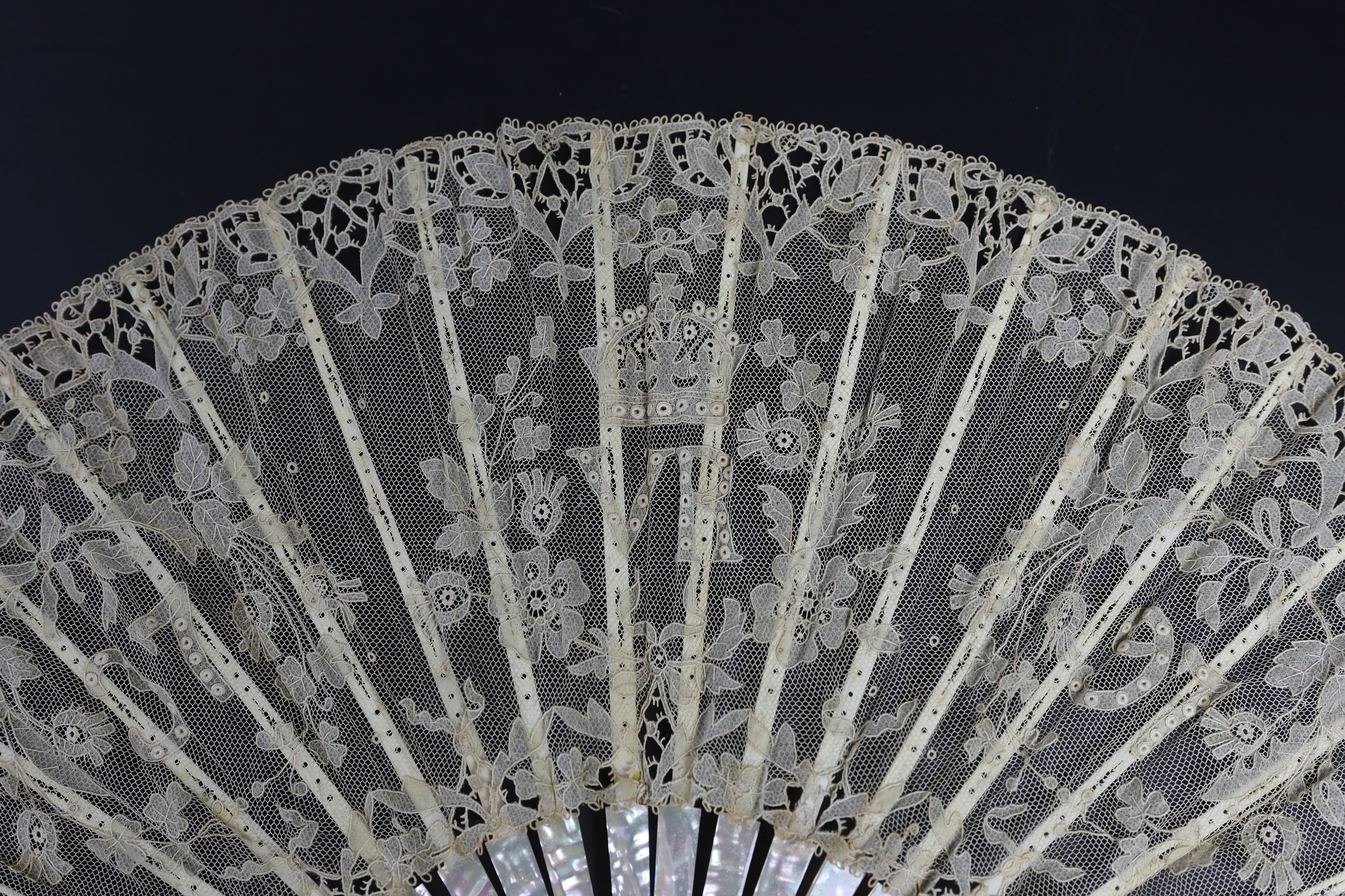 An unusual commemorative Carrickmacross lace fan, possibly one made and entered for a group of competitions held by the Worshipful Company of Fan Makers, the winning fan to be presented to Queen Victoria as a gift for he